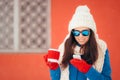 Winter Girl With Hot Beverage Checking Her Smartphone Royalty Free Stock Photo