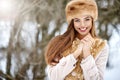 Winter girl portrait. Beautiful smiling woman in snowy park Royalty Free Stock Photo