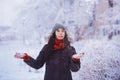 Winter girl in red gloves and scarf blowing snow. Beauty Joyful Teenage Model Girl having fun in winter park. Beautiful girl laugh Royalty Free Stock Photo