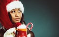 Winter girl santa helper hat holds red mug Royalty Free Stock Photo