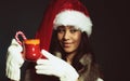 Winter girl santa helper hat holds red mug Royalty Free Stock Photo
