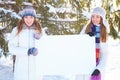 Winter. Girls with blank banner. Royalty Free Stock Photo
