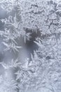 Winter glass pane with fancy icy pattern with frozen water drops.