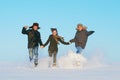 Happy young people running winter outdoors Royalty Free Stock Photo