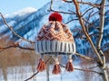 a winter hat lies weighs on a tree branch