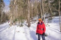 Woman stands on sunny snowshoe trail in winter Royalty Free Stock Photo