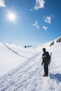 Winter hiker at snowy footpath Rofan alps, bright sunshine, vertical shot Royalty Free Stock Photo