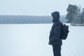 Winter hiking sportsman looking at snowy plain wood amazing landscape