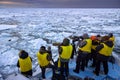 Winter Hokkaido, arctic polar photographic safari with eagles on the sea ocean ice. People with yellow vest on the boat vessel. Royalty Free Stock Photo