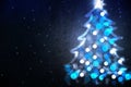 Winter holiday background with blue Christmas tree shape from lights Royalty Free Stock Photo