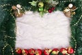 Winter holiday background. Border with Christmas tree branches and ornaments isolated on whitch. Fir needles garland, frame with Royalty Free Stock Photo