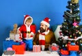 Winter holiday and celebration concept. Santa and little assistant Royalty Free Stock Photo