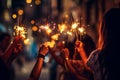 Winter holiday celebration group of happy people enjoying fireworks with glowing sparkles in hands