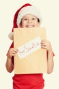 Winter holiday christmas concept - boy in hat with letter to santa on white isolated Royalty Free Stock Photo