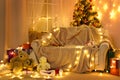 Winter holiday concept - Interior with new year or christmas decoration. At night, the room glows with festive lights. A lots of Royalty Free Stock Photo