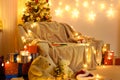 Interior with new year or christmas decoration. At night, the room glows with festive lights. A lots of gifts and decorations. Royalty Free Stock Photo