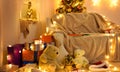 Interior with new year or christmas decoration. At night, the room glows with festive lights. A lots of gifts and decorations. Royalty Free Stock Photo