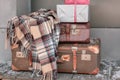 Plaid wool blanket and vintage suitcases with Christmas packages Royalty Free Stock Photo