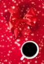 Winter holiday gift box, coffee cup and glowing snow on red flatlay background, Christmas time present surprise Royalty Free Stock Photo