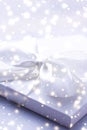 Winter holiday gift and glowing snow background, Christmas presents surprise