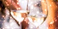 Winter holiday glasses of white wine and glowing snow on background, Christmas time romance Royalty Free Stock Photo