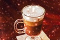 Winter holiday latte coffee glass and glowing snow in a restaurant, Christmas time menu recipe Royalty Free Stock Photo