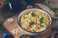 Winter holiday salad. Russian traditional salad Olivier with vegetables and chicken on table. Traditional Russian cuisine.