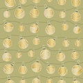 Winter holiday seamless pattern with golden decorated Christmas balls on strings on green background. Royalty Free Stock Photo