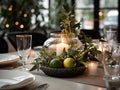 Winter holiday season festive dining table decoration with candles and beautiful tableware, elegant table decor