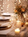 Winter holiday season festive dining table decoration with candles and beautiful tableware, elegant table decor