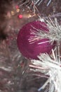 Winter Holiday silver white tinsel Christmas tree with pink magenta ornaments and lights Royalty Free Stock Photo