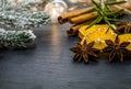 Winter holiday still life concept on dark slate board with dried spices and sprigs