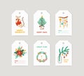 Winter holiday tags set. Christmas labels decorated with pine tree, xmas wreath, seasonal flowers and cute cat on white