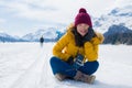 Winter holiday trip to snow valley - young happy and excited Asian Chinese woman playful on frozen lake in snowy mountains at