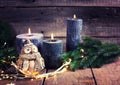 Winter holidays  background. Black candles, owl and fir tree branches Royalty Free Stock Photo