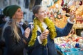 Winter holidays and celebration concept - happy mother and teenager daughter at christmas market closeup Royalty Free Stock Photo