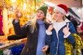 Winter holidays and celebration concept - happy mother and teenager daughter at christmas market closeup Royalty Free Stock Photo