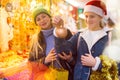 Winter holidays and celebration concept - happy mother and teenager daughter at christmas market closeup