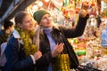Winter holidays and celebration concept - happy mother and teenager daughter at christmas market closeup