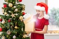 surprised girl opening christmas gift at home Royalty Free Stock Photo