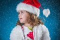 winter, holidays, christmas concept - beautiful little girl having fun with snow flakes, studio shot. Royalty Free Stock Photo