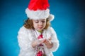 winter, holidays, christmas concept - beautiful little girl having fun with snow flakes, studio shot. Royalty Free Stock Photo