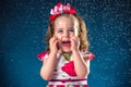 winter, holidays, christmas concept - beautiful little girl having fun with snow flakes, studio shot Royalty Free Stock Photo