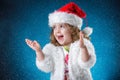 winter, holidays, christmas concept - beautiful little girl having fun with snow flakes, studio shot Royalty Free Stock Photo