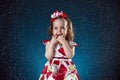 winter, holidays, christmas concept - beautiful little girl having fun with snow flakes, studio shot. Royalty Free Stock Photo