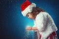 winter, holidays, christmas concept - beautiful little girl having fun with snow flakes, abstract background Royalty Free Stock Photo