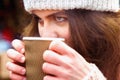 Winter holidays, christmas, hot drinks and people concept. Close up portrait of beautiful young woman tourist in warm clothes Royalty Free Stock Photo