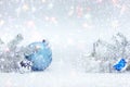 Winter holidays composition on white snow with christmas tree branches, decorative blue ball, silver glass star and drums toy Royalty Free Stock Photo