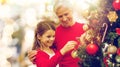 Grandmother and granddaughter at christmas tree Royalty Free Stock Photo