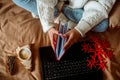 Winter holidays morning. Woman having breakfast with cup of coffee latte in hands in bed. Coziness weekend. Relaxing Sunday Royalty Free Stock Photo